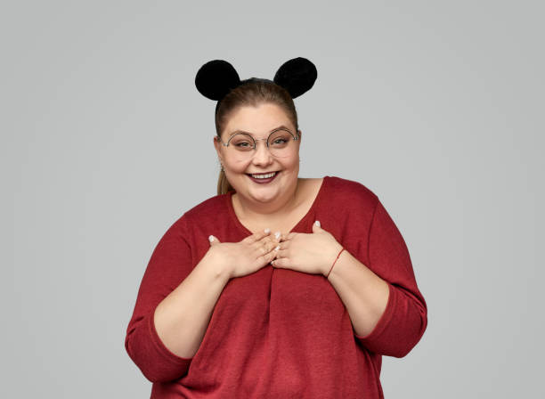 istock Pleased plump woman with mouse ears 1163538684