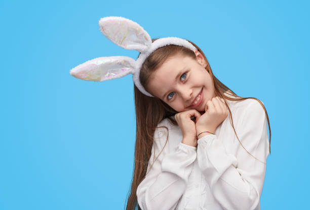 istock Cute girl in white ears on blue background 1163538700