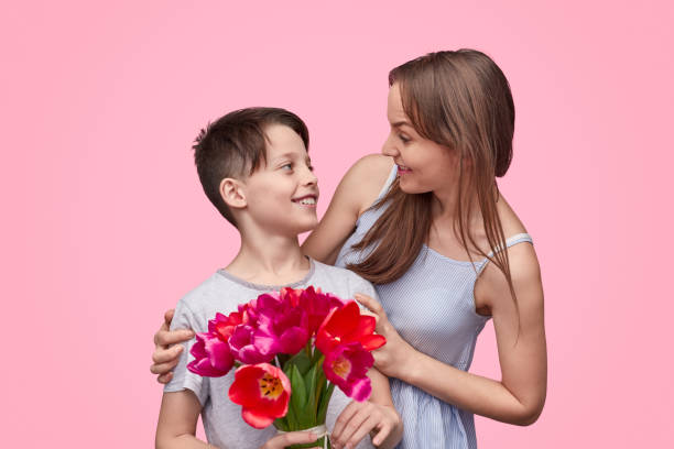 istock Mother looking at son with bouquet 1163538717