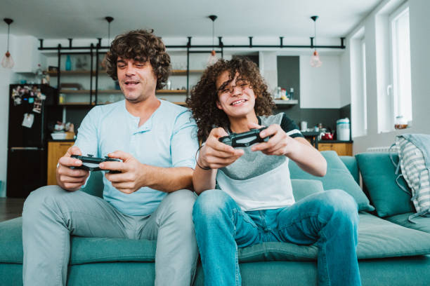 istock Father and son playing digital games at home 1163539337