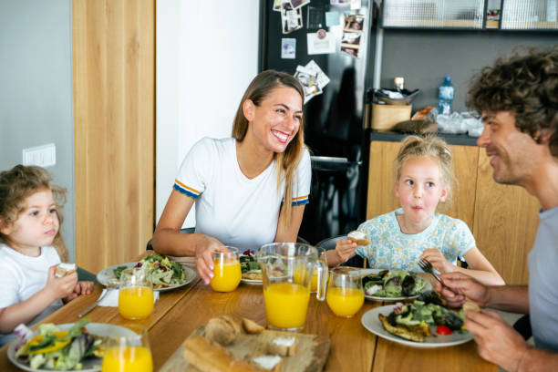 istock Young family eating together at home. 1163539357