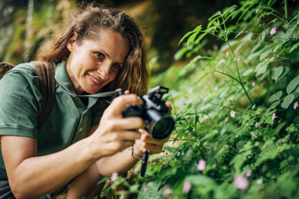 istock Lady biologist taking pictures with camera outdoors in nature 1163542813
