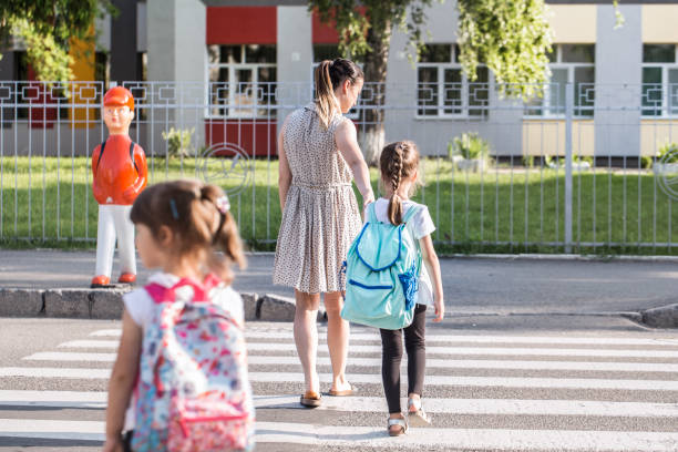 istock Back to school education concept with girl kids, elementary students, carrying backpacks going to class 1163544505