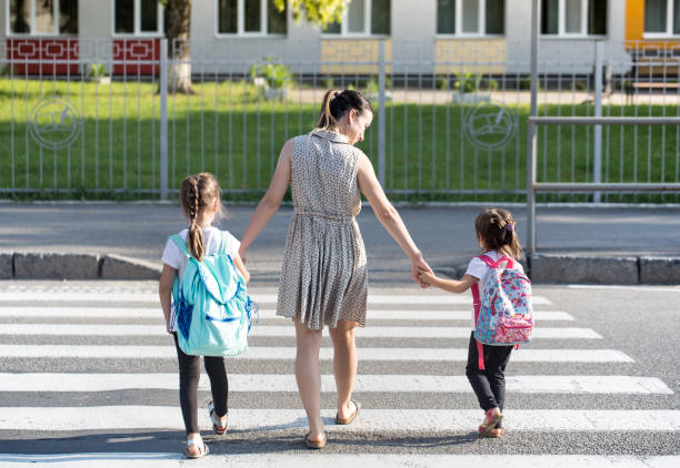 istock Back to school education concept with girl kids, elementary students, carrying backpacks going to class 1163544511