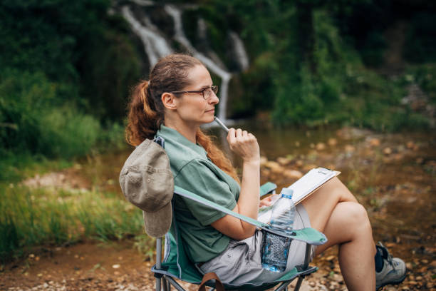 istock Woman biologist taking notes in nature 1163544531
