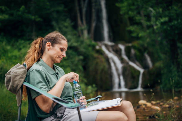 istock Woman biologist taking notes in nature 1163544534