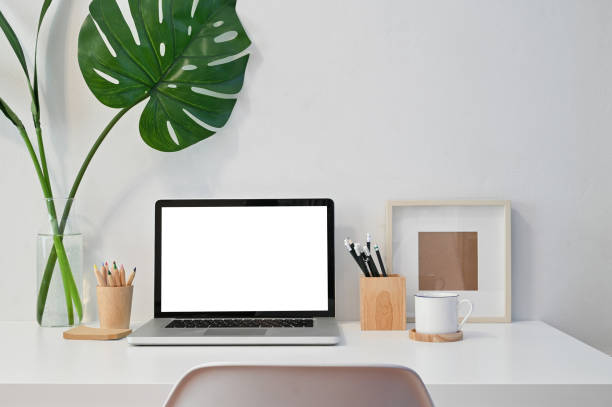 istock Workspace Laptop computer, coffee, pencil, photo frame and plant decoration on table. 1163544714