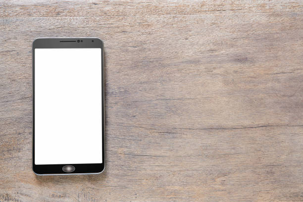 istock Smartphone with white screen on vintage grunge wooden background 1163545728