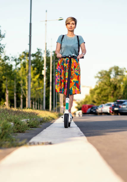 istock Business woman using electric scooter 1163545919
