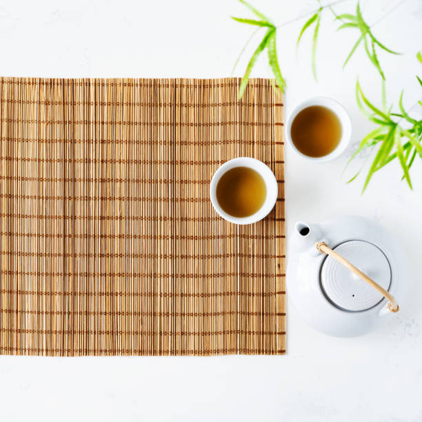 istock Asian food background with tea set nature bamboo mat on white background. 1163546203