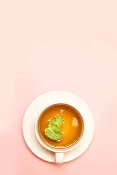 istock Creative concept of white ceramic cup with herbal green or black tea with mint leaves 1163547206
