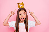 Photo of little lady holiday time hands indicate headwear open mouth coronation wear sun dress isolated pink background