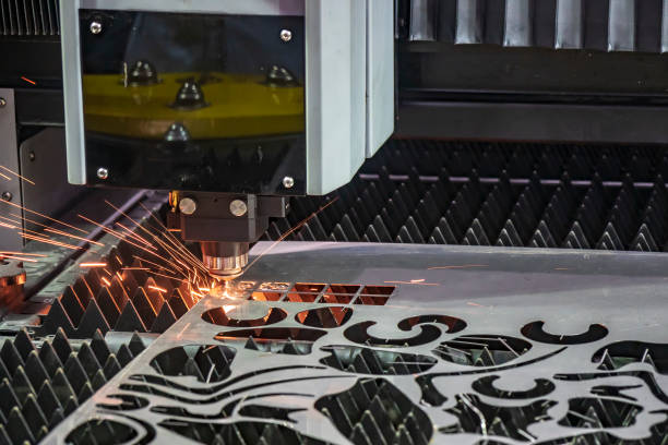 The laser cutting machine cutting the metal plate. The laser cutting machine cutting the metal plate. The sheet metal process with fiber laser cutting machine. equipment accuracy laser flame stock pictures, royalty-free photos & images