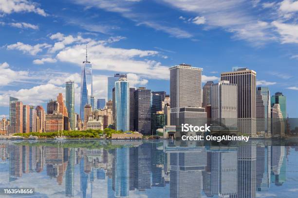 New York City Skyline With Manhattan Financial District And World Trade Center Reflected In Water Of New York Harbor Ny Usa Stock Photo - Download Image Now