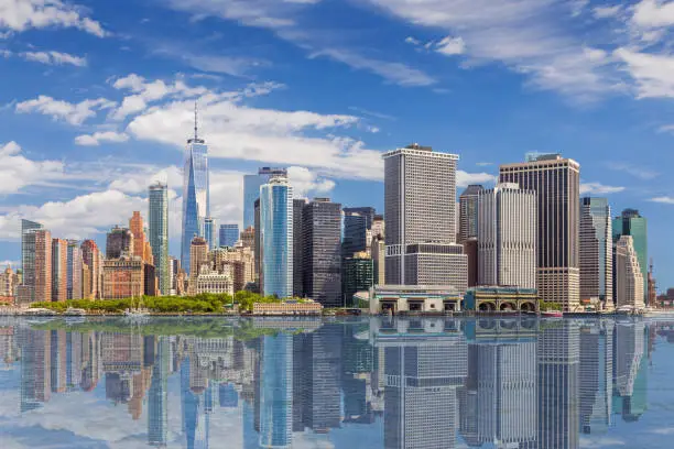 Photo of New York City Skyline with Manhattan Financial District and World Trade Center Reflected in Water of New York Harbor, NY, USA.