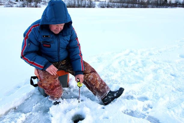 istock Fisherman Winter on the Lake 1163555886