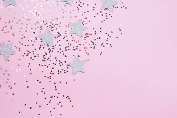 istock Star shaped confetti on pastel pink background 1163556582