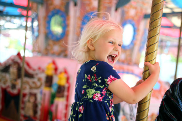 istock Happy Little Kid Riding Carousel at Carnival 1163556791