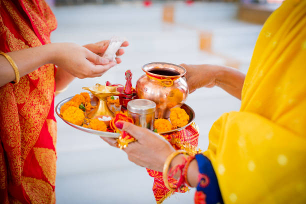 Religious Women at a Hindu Temple Getting Ready for the Prayers Hindu, Women, Faith, Devotion, Festival - Women Holding a Tray Containing Prayer Articles for Hindu Prayers at a Temple ganesh chaturthi photos stock pictures, royalty-free photos & images