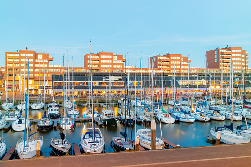 Evening view of Scheveningen harbour with boats, bars and restaurants in The Hague, The Netherlands