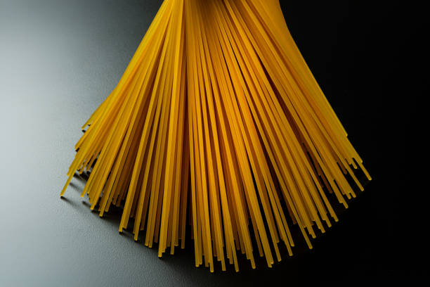 istock Detail of spaghetti made with pasta with eggs on background lit by one side 1163561488