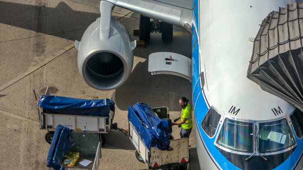 Hanover, Germany, July 17., 2019: loading a passenger plane at the gate on the airport tarmac with the passengers' suitcases