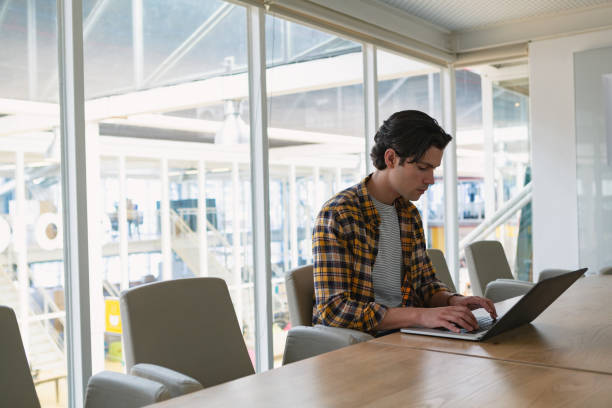 istock Male executive using laptop in the conference room 1163564175