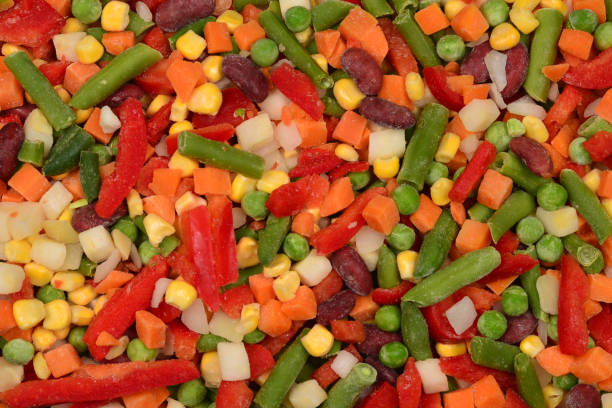 istock Sliced vegetables, corn, beans, peas, carrots, sweet peppers background. 1163564217