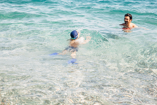 Father and son enjoying sea