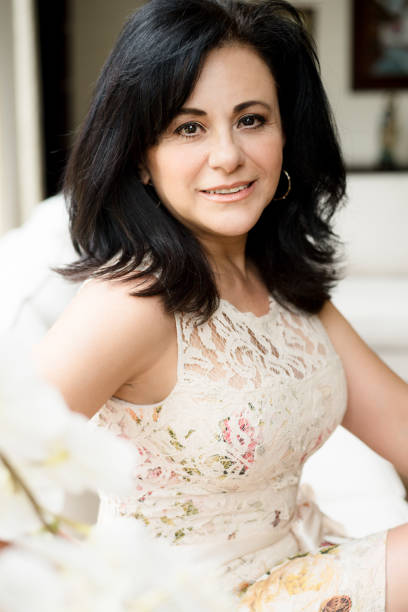 istock Smiling mature woman posing and looking at camera 1163568257