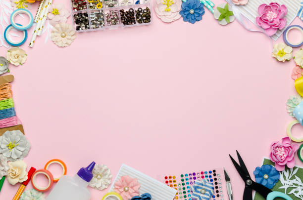 istock Paper flowers, scissors, paper and scrapbooking items on pink background 1163569907