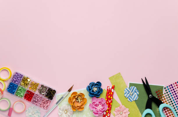 istock Paper flowers, tools, paper and scrapbooking items on pink background 1163569910