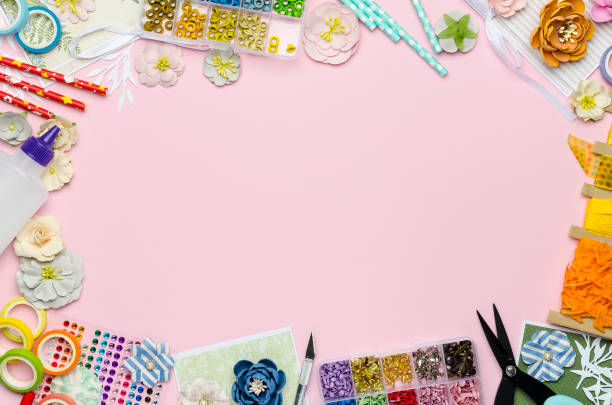 istock Paper flowers, scissors, paper and scrapbooking items on pink background 1163569945