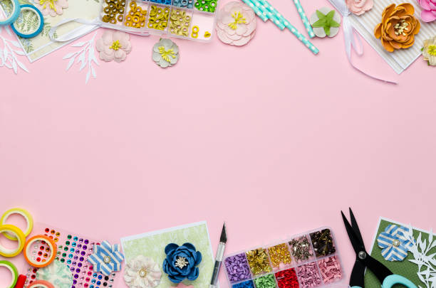 istock Paper flowers, tools, paper and scrapbooking items on pink background 1163569948