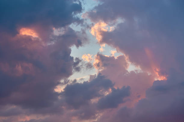 istock Pink clouds illuminated by the sun in the blue sky 1163571105