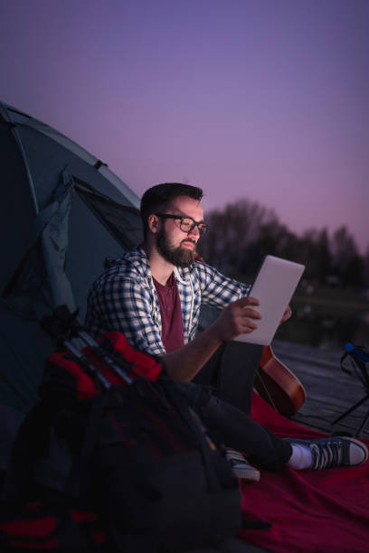 camping freelance junto al lago - hipster people surfing the net internet fotografías e imágenes de stock