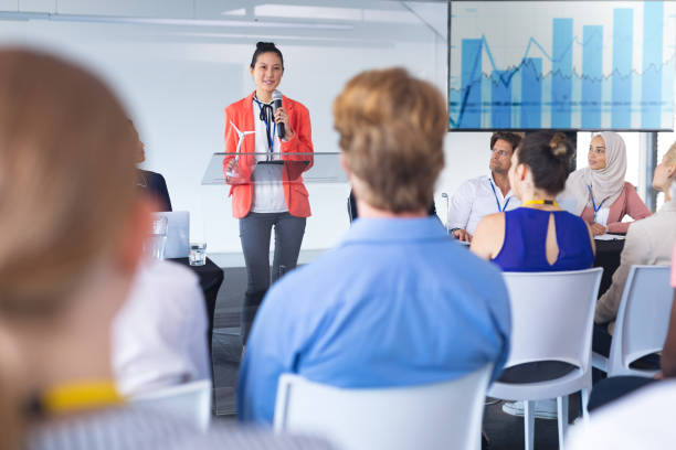 istock Female speaker speaks in a business seminar 1163572916