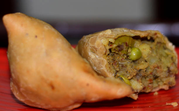 istock Popular indian snack samosa With filling in focus 1163574778