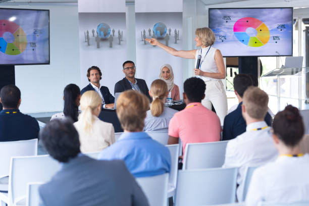 istock Female speaker giving presentation in a business seminar 1163575351