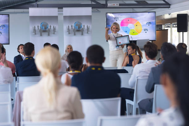 istock Female speaker announcing award in a business seminar 1163575407