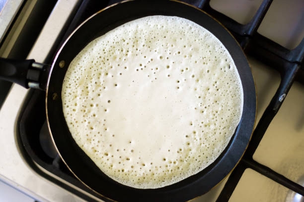 Pancake cooking in a pan seen from above
