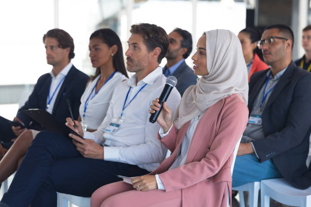 istock Businesswoman in hijab asking question during seminar 1163576316