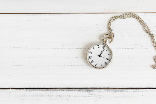 istock Necklace pocket watch on white wood table with copy space. 1163579358