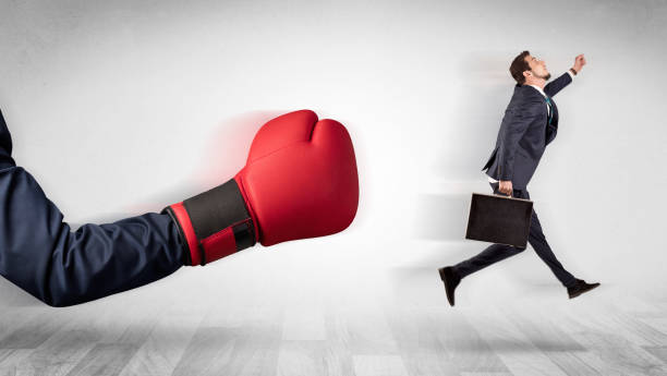 istock Red boxing glove knocks out little businessman 1163579404