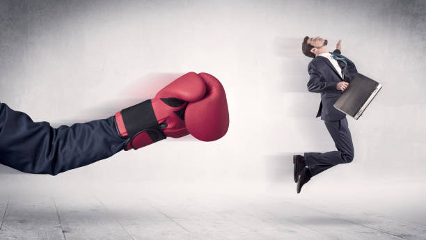 istock Huge Boxing Gloves punches businessman concept 1163579469