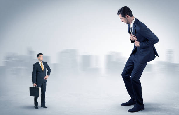 istock Giant businessman is  afraid of small executor 1163579531