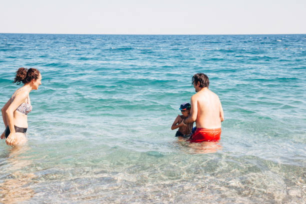 istock Parents with children enjoying sea 1163579585