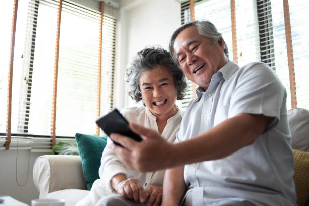istock Happy Asian senior Couple using smartphone. 1163579795
