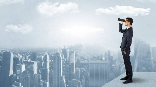 istock Man looking forward from the top of a skyscraper 1163580524