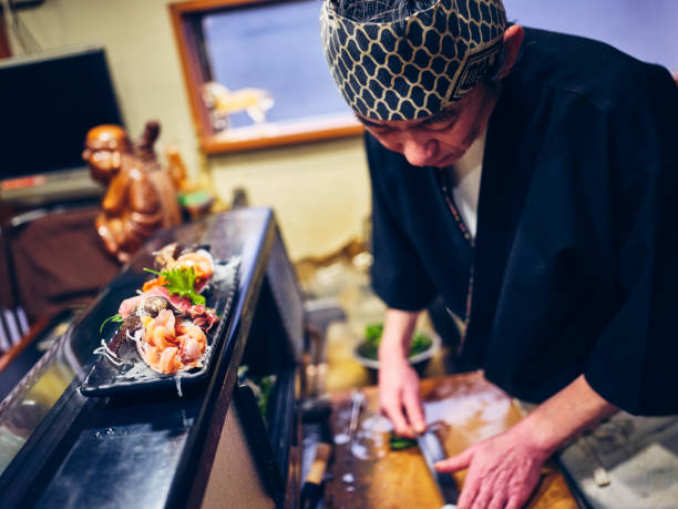 istock Japanese Sushi Chef in a Sushi Shop 1163581120